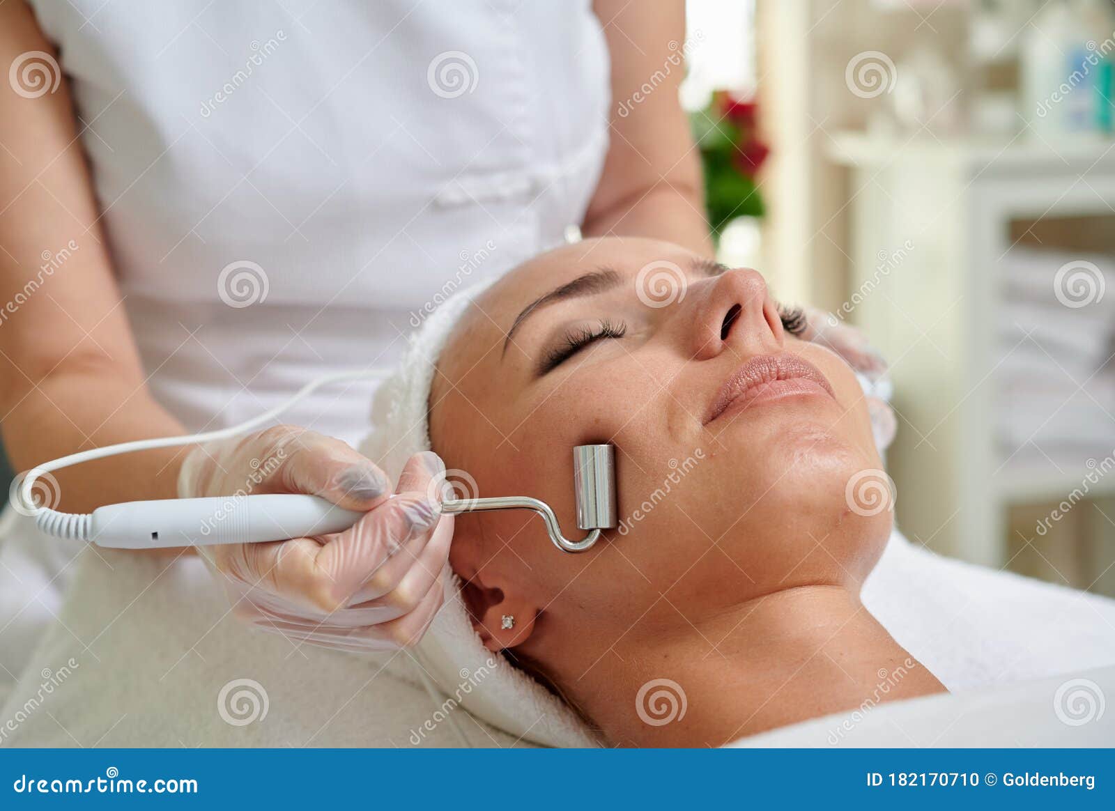 female receiving microcurrent therapy in spa cosmetologist professional services