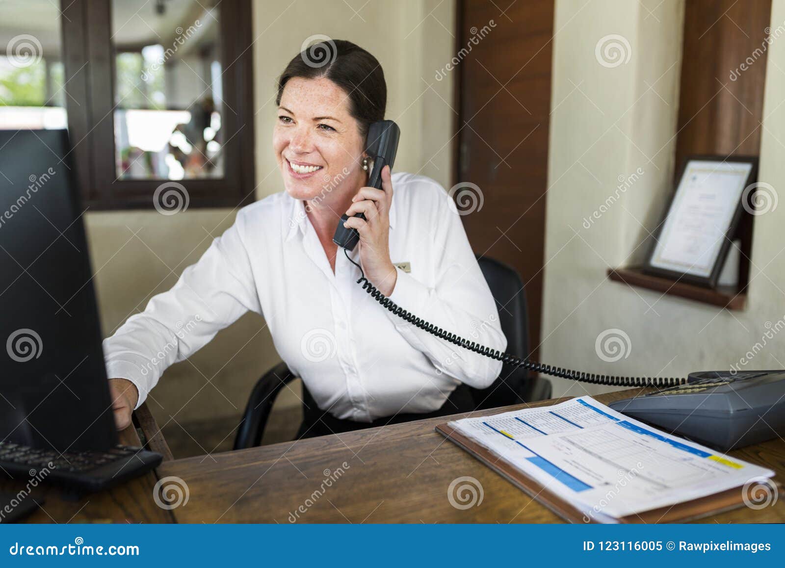 female resort receptionist working at the front desk