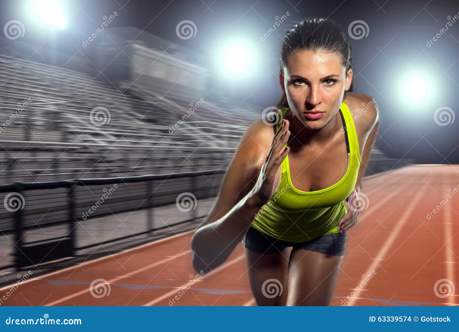 Portrait of a female athlete on a black background. Woman sprinter