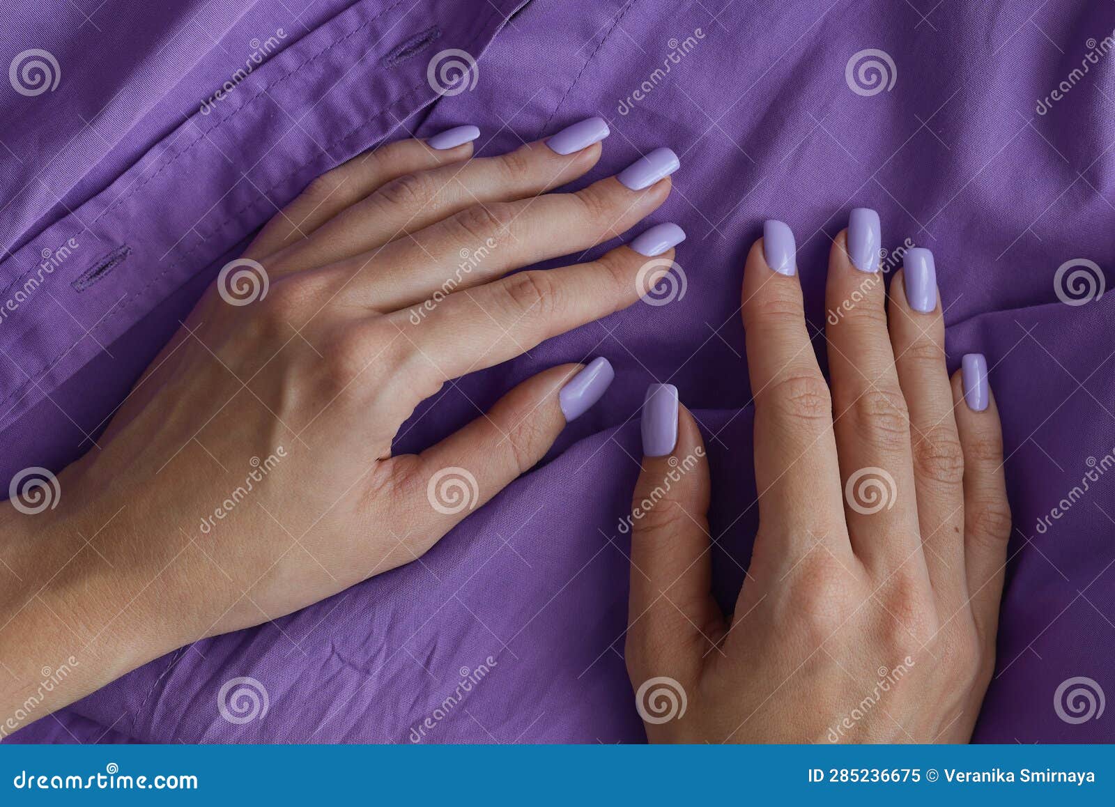 female's hands with gelish manicure and nails of purple color