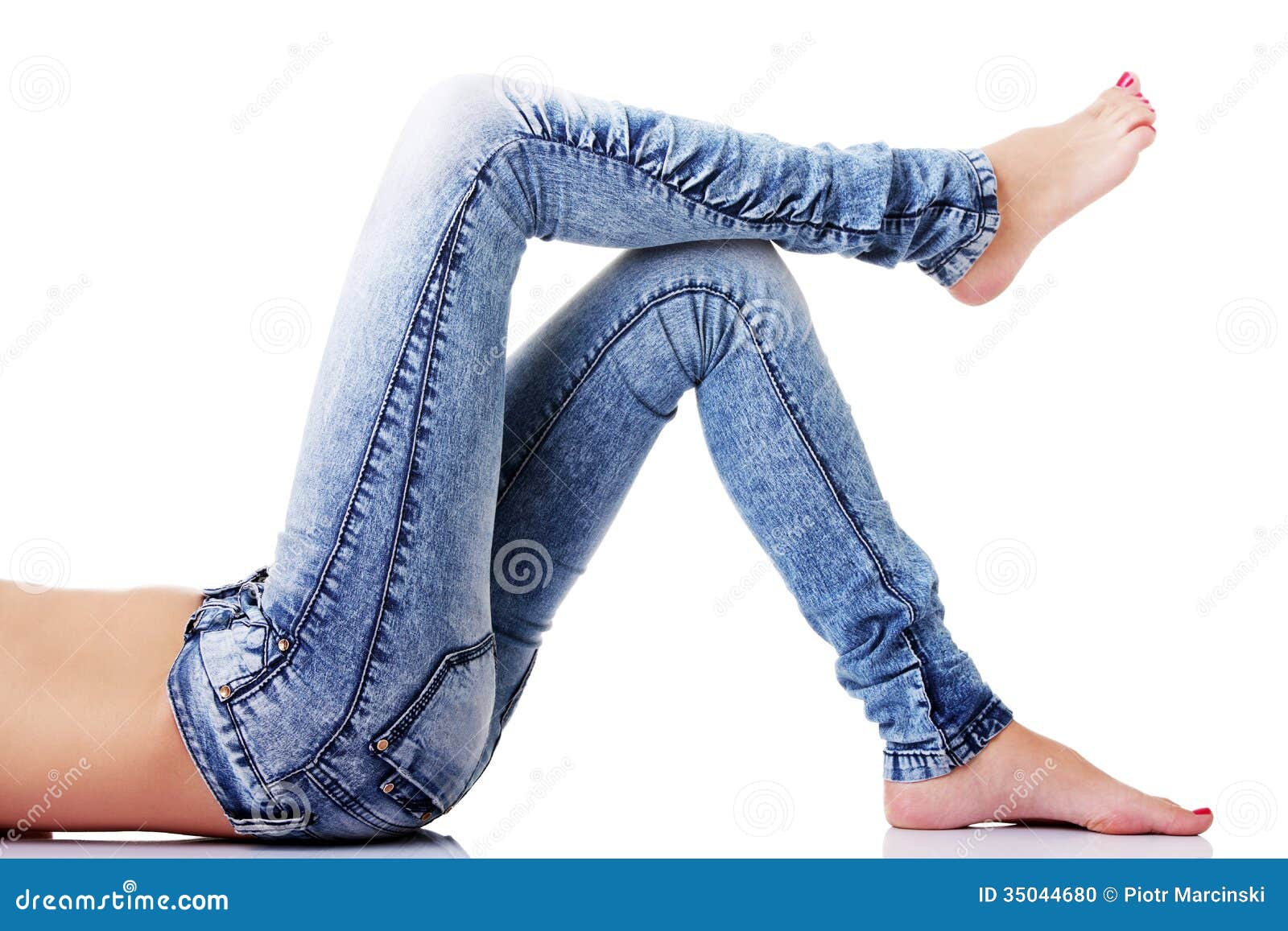 Female's Legs In Jeans On The Floor. Side View. Stock Photo - Image of