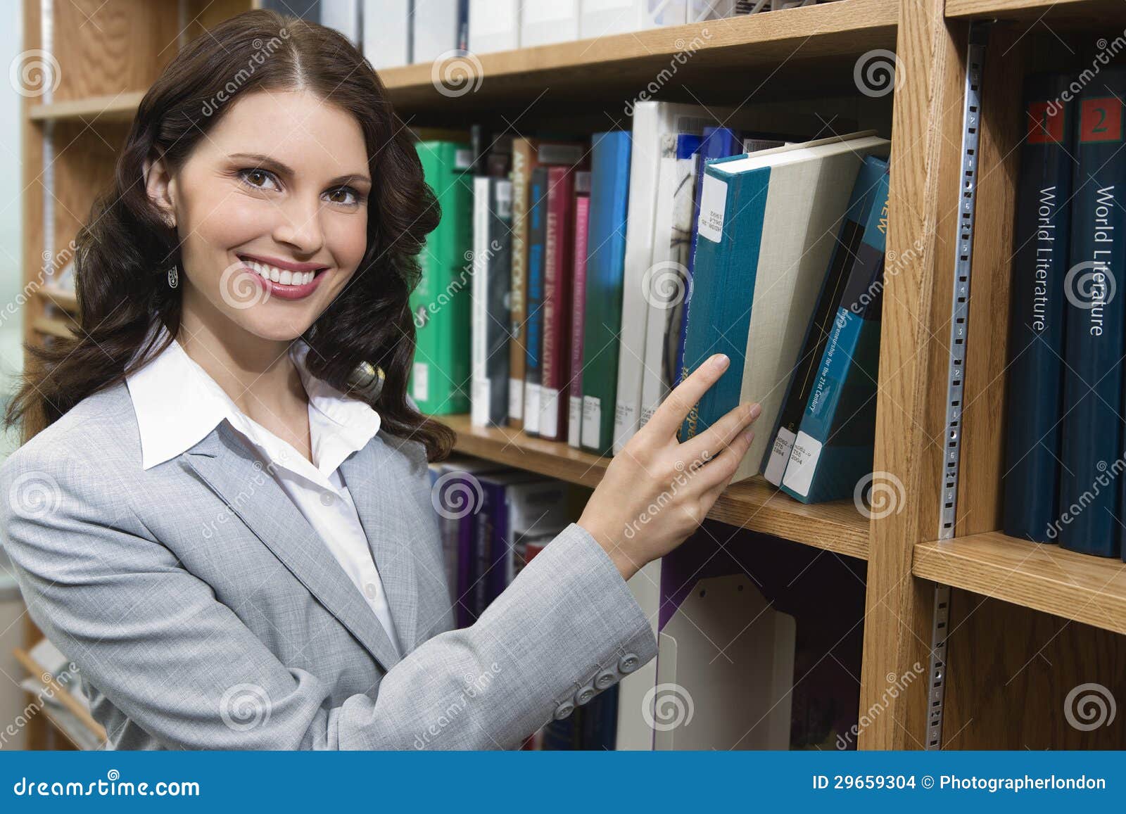 female selecting book from shelf