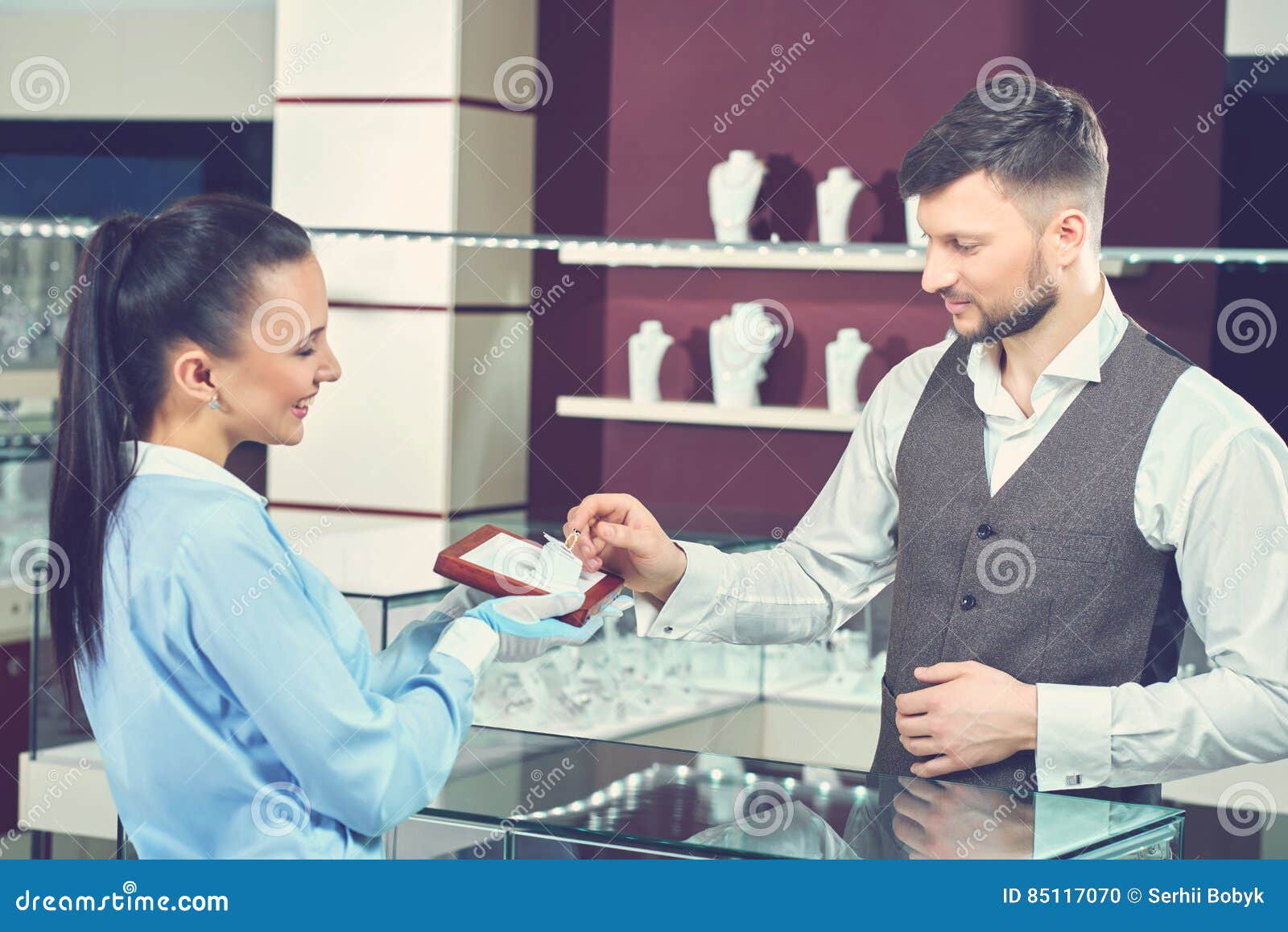 Female Seller in Jewelry Store Showing Golden Ring for Buyer. Stock ...