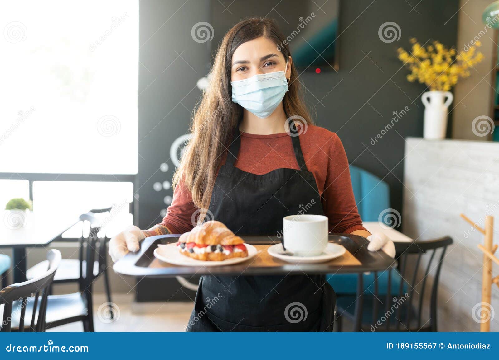 female server with order in tray at cafe