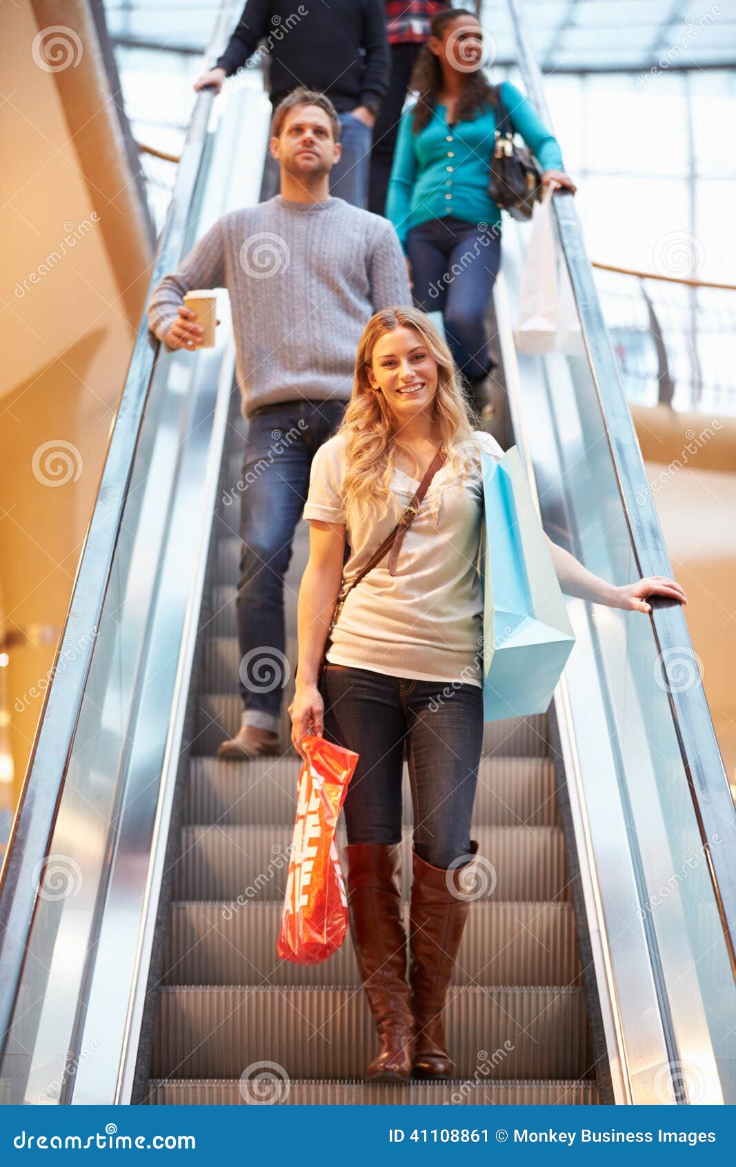 Female Shopper on Escalator in Shopping Mall Stock Image Image of