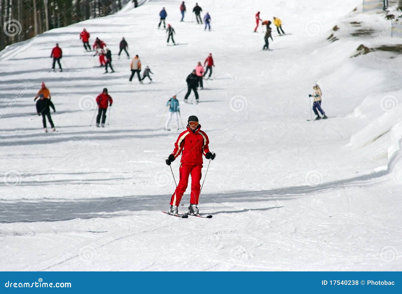 female skier skiing down a piste