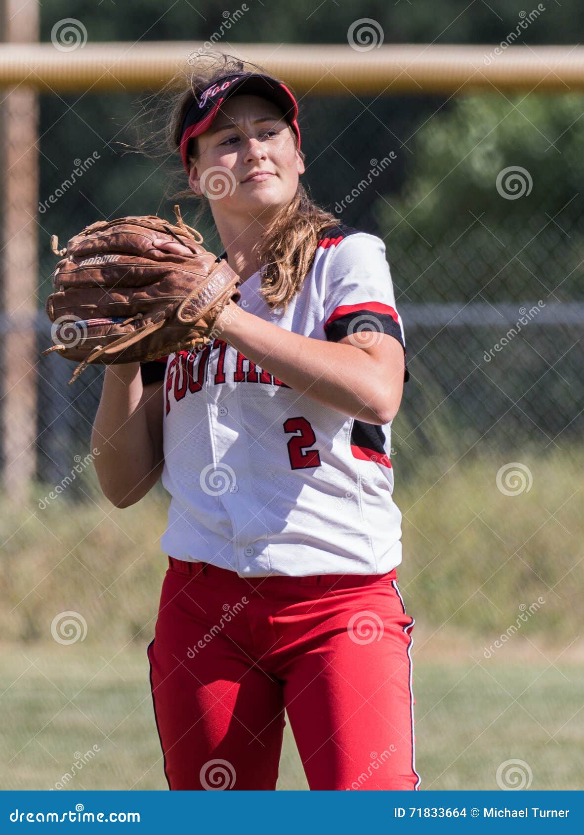 Female Fastpitch Softball Player Heading Into The Batters Box Sizing Up The Pitcher Stock Image