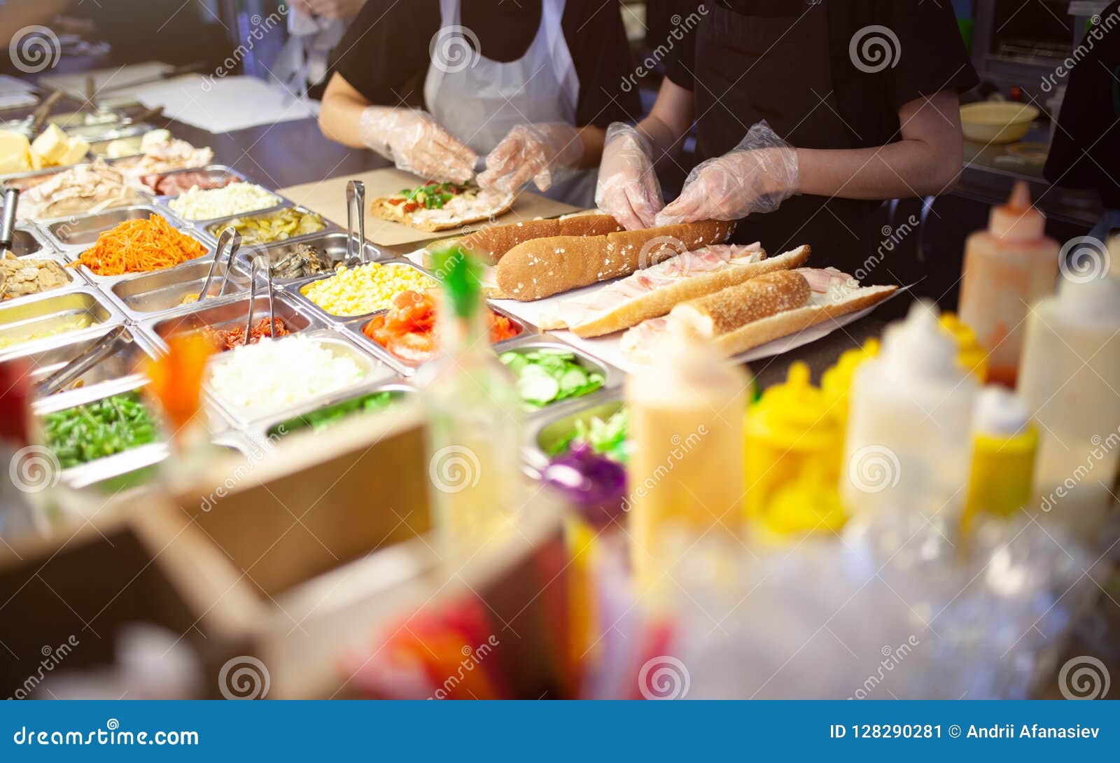 https://thumbs.dreamstime.com/z/female-street-vendor-hands-making-sandwich-outdoors-cuisine-snacks-cooking-fast-food-commercial-kitchen-range-products-128290281.jpg