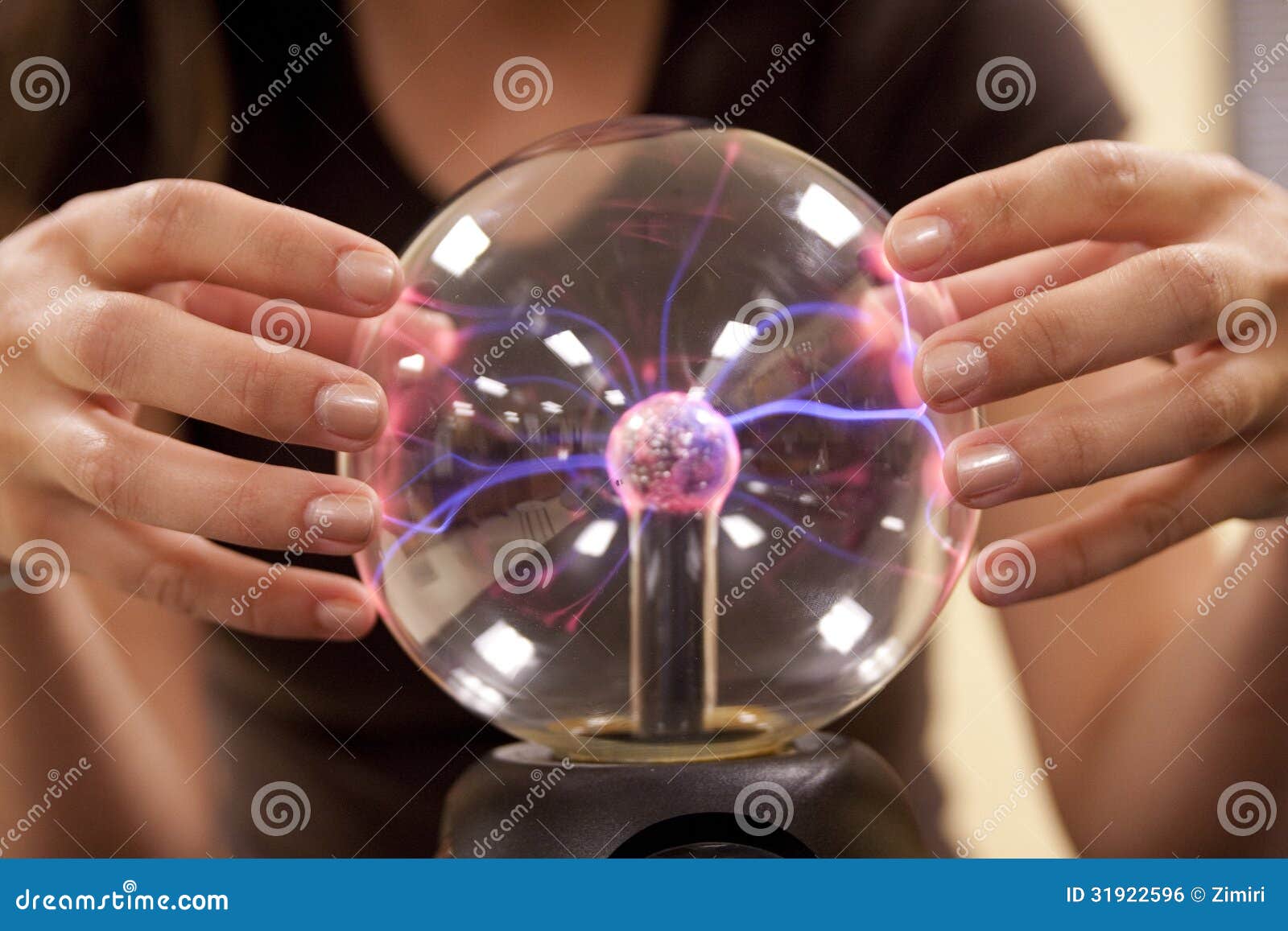 female student touching a plasma ball.