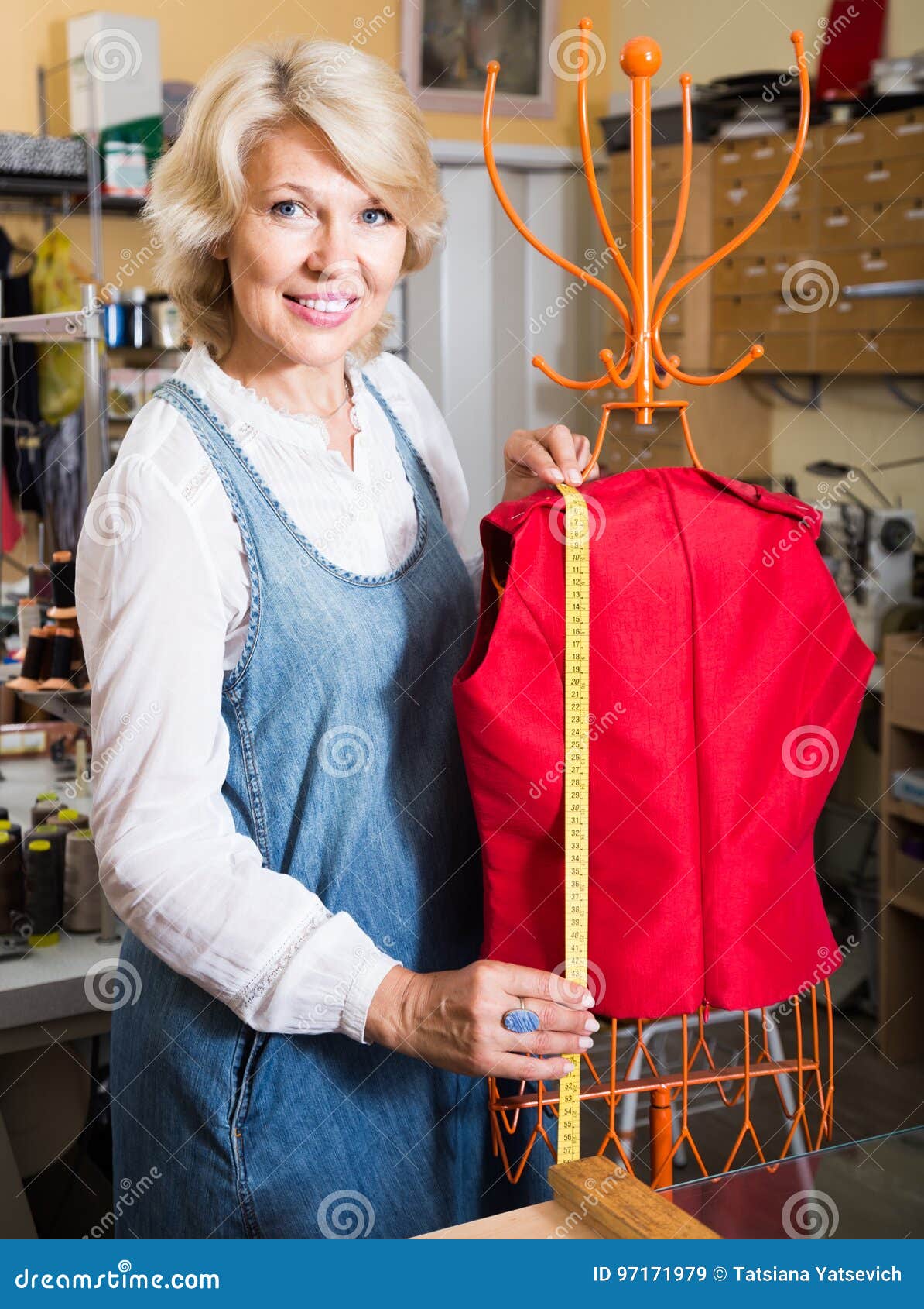 Female Tailor Working Near Mannequin in Sewing Stock Image
