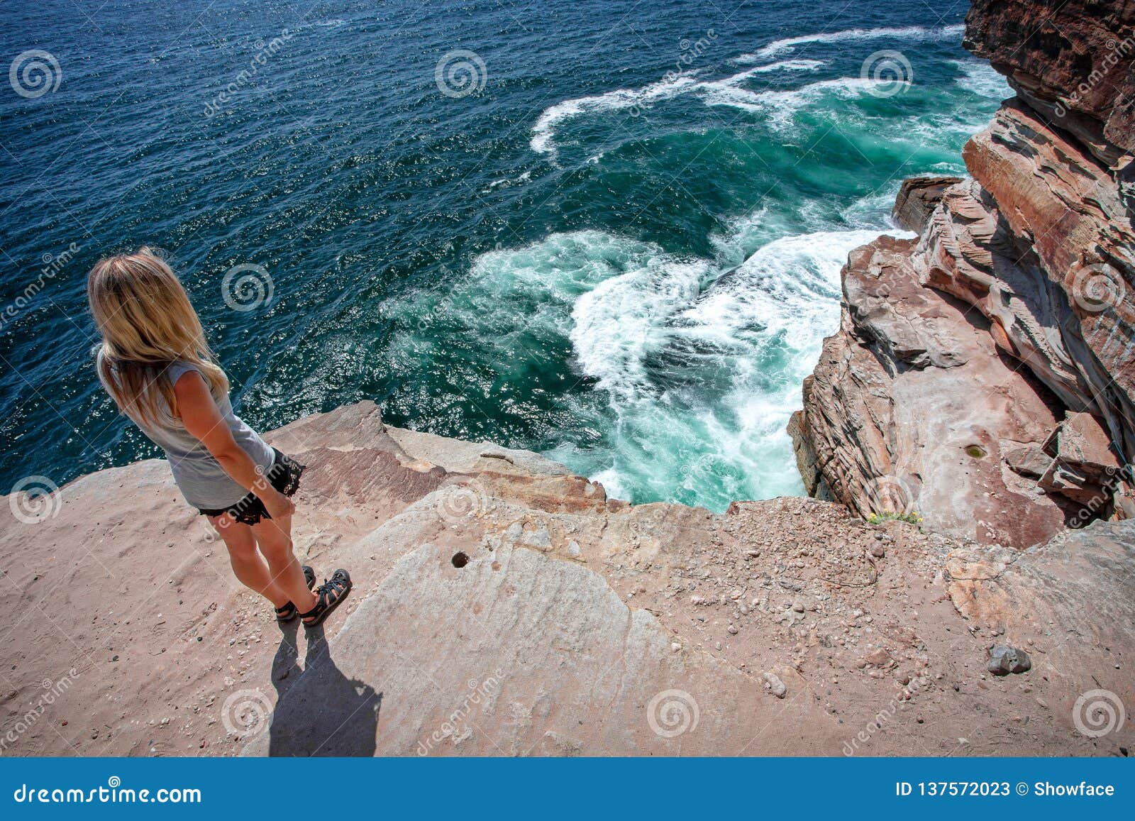 Female Takes In The Ocean Views From Cliff Top Ledge Royalty Free Stock Photo Cartoondealer