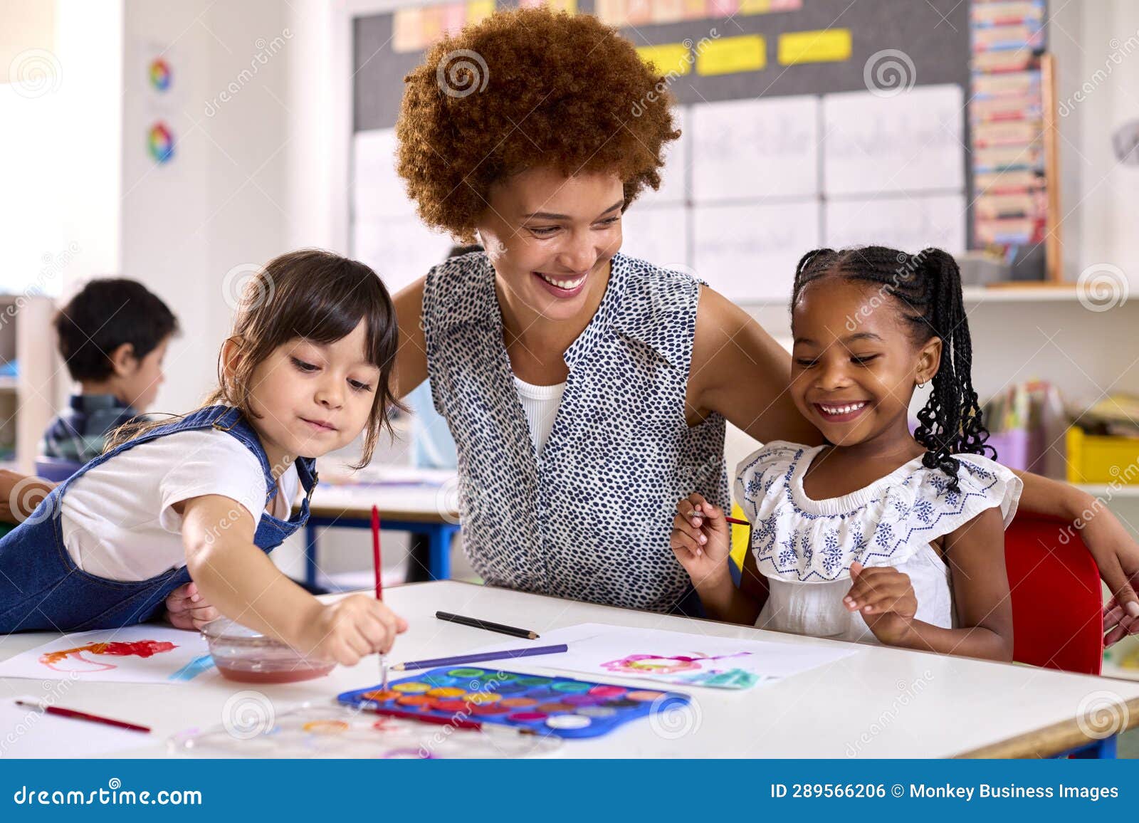 Female Teacher with MultiCultural Elementary School Pupils in Art