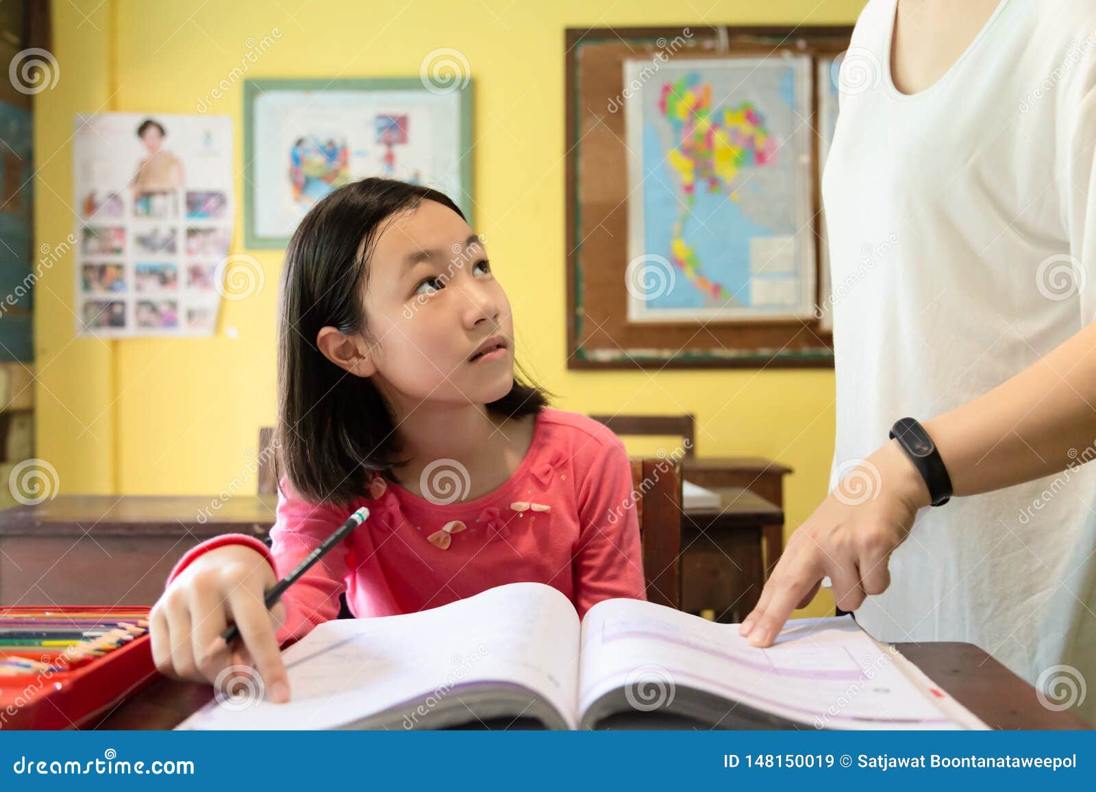 Female Teacher Teaching Student At School Teacher Helping Little