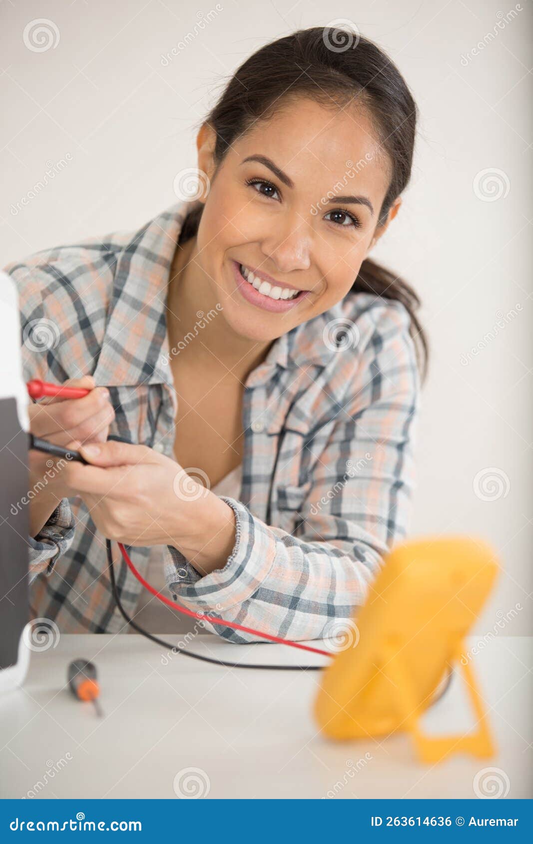 Female Tech Repairs Electronic Device in Hardware Repair Shop Stock