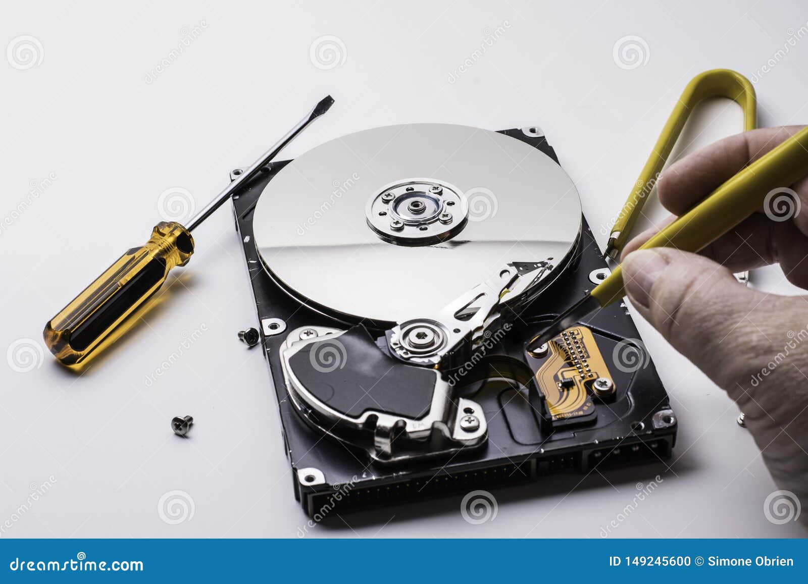 Female Technician Hand Holding And Working On Computer Hard Drive With