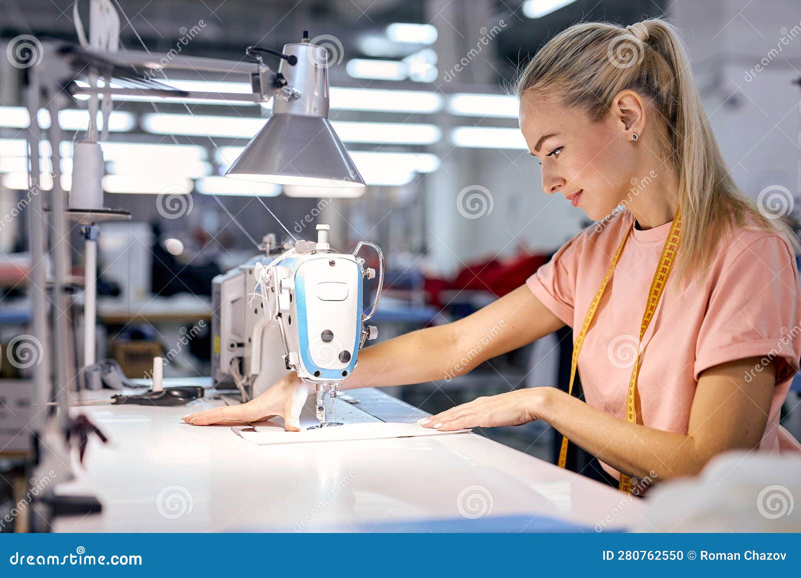 Female Textile Factory Worker on Production Line Using Modern Sewing