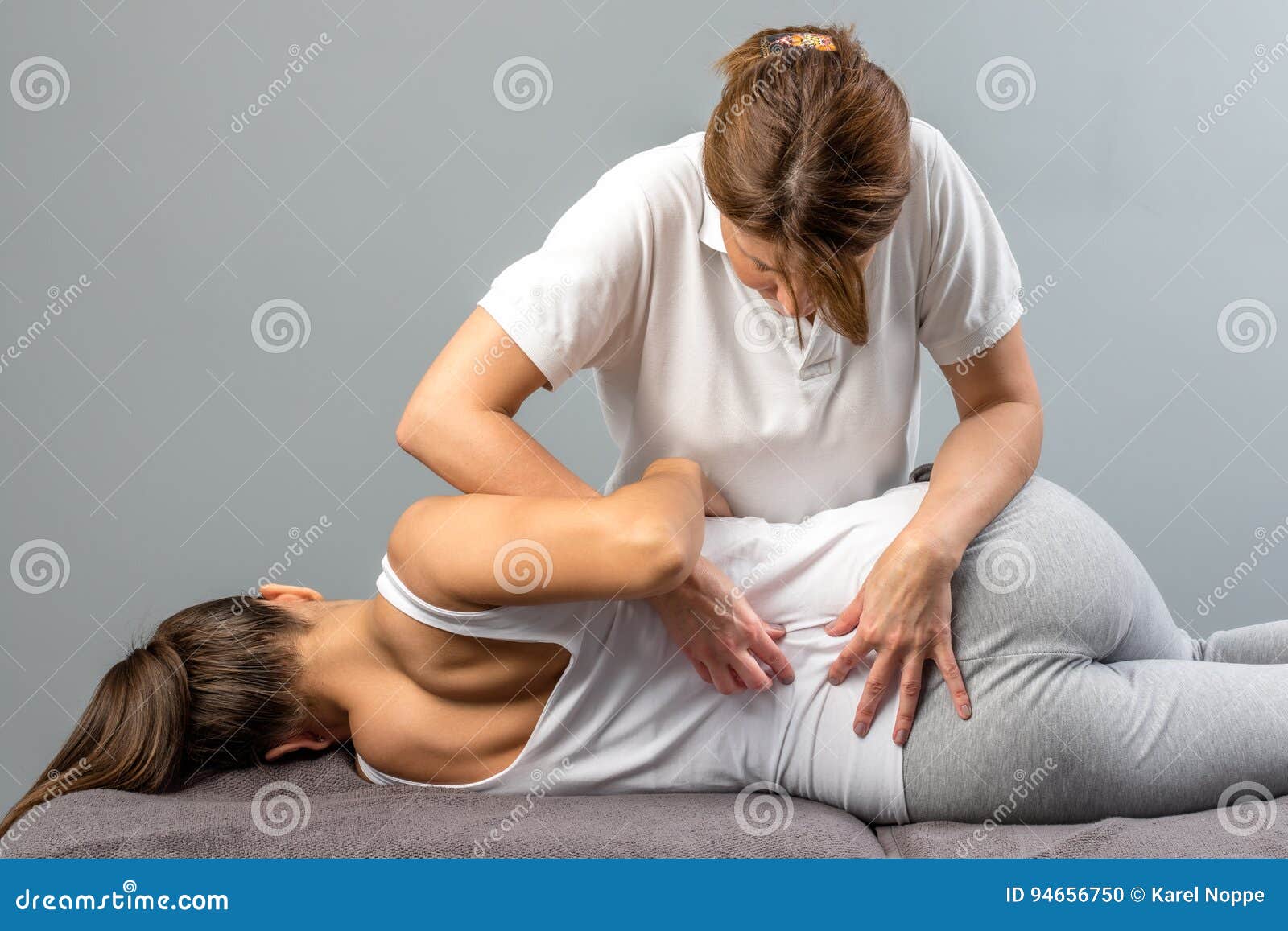 female therapist doing osteopathic spine treatment on patient.