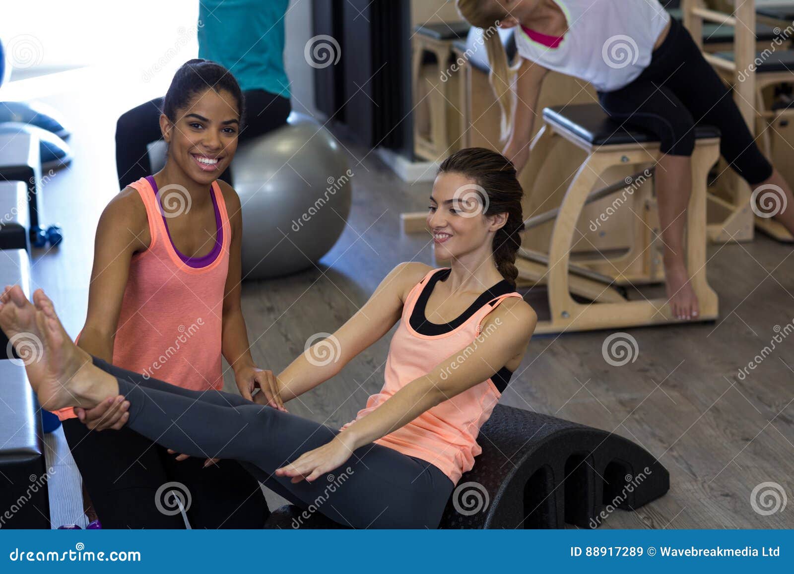 Female Trainer Assisting Woman with Stretching Exercise on Arc Barrel Stock  Image - Image of adult, effort: 88917289