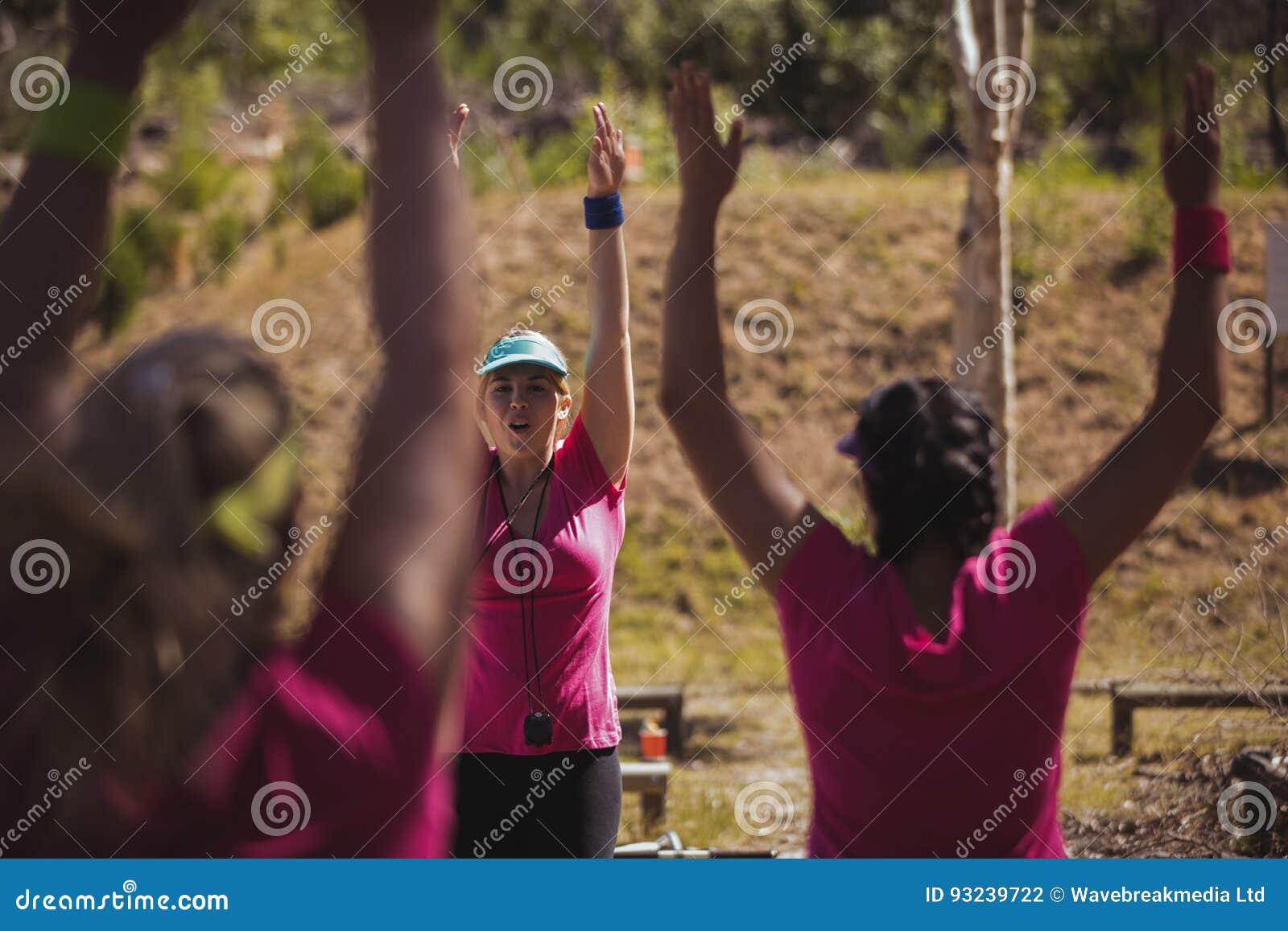 Female Trainer Instructing Women While Exercising In The Boot Camp