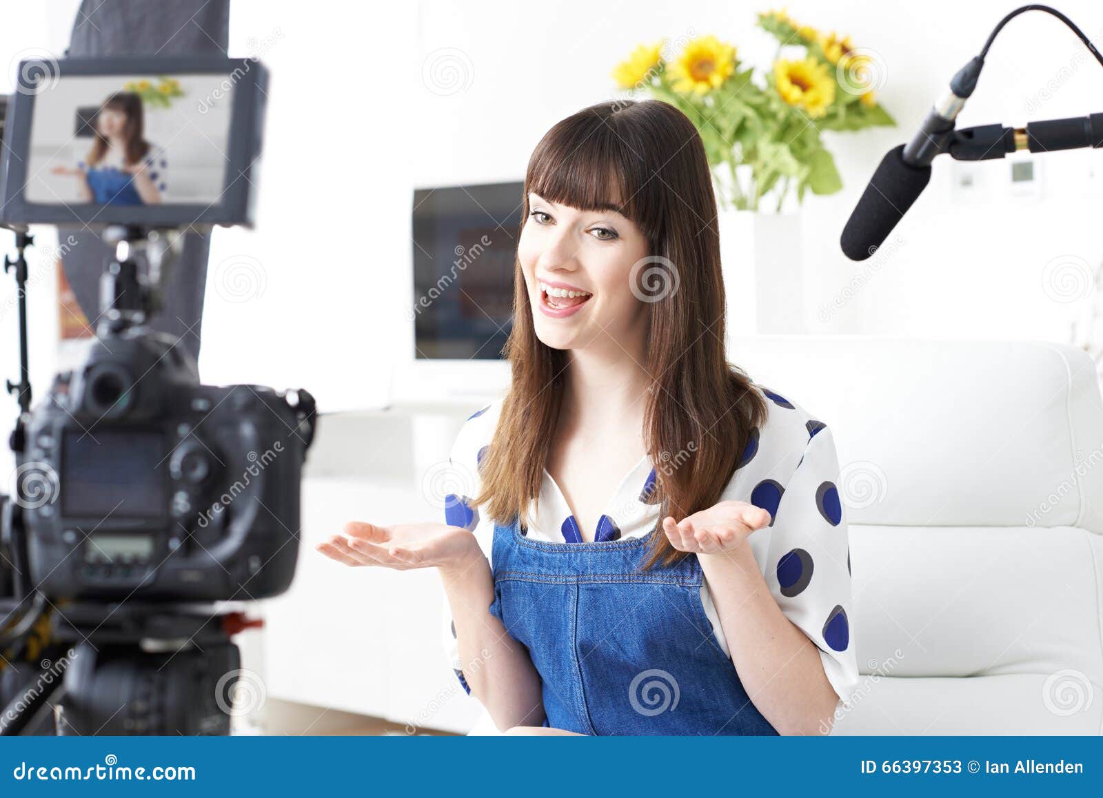 female vlogger recording broadcast at home