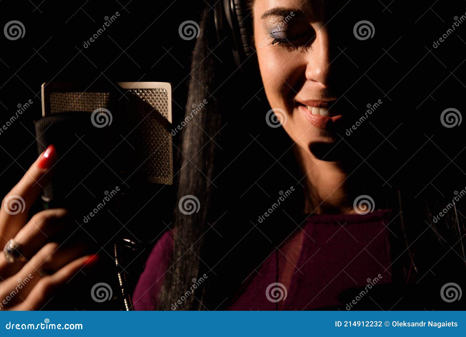 Female Vocal Artist Singing in a Recording Studio. Stock Photo Image