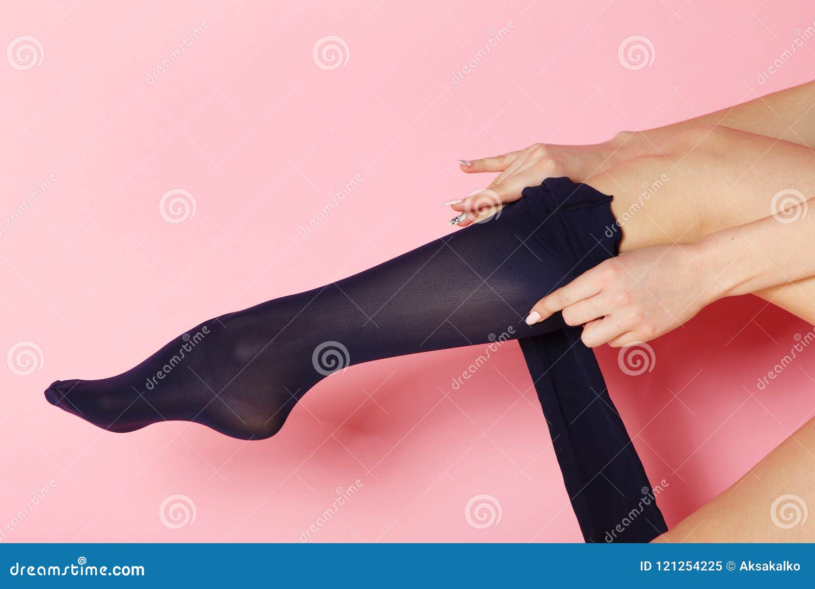 Healthy Teen In Black Tights Stands With Hands On Hips Looking