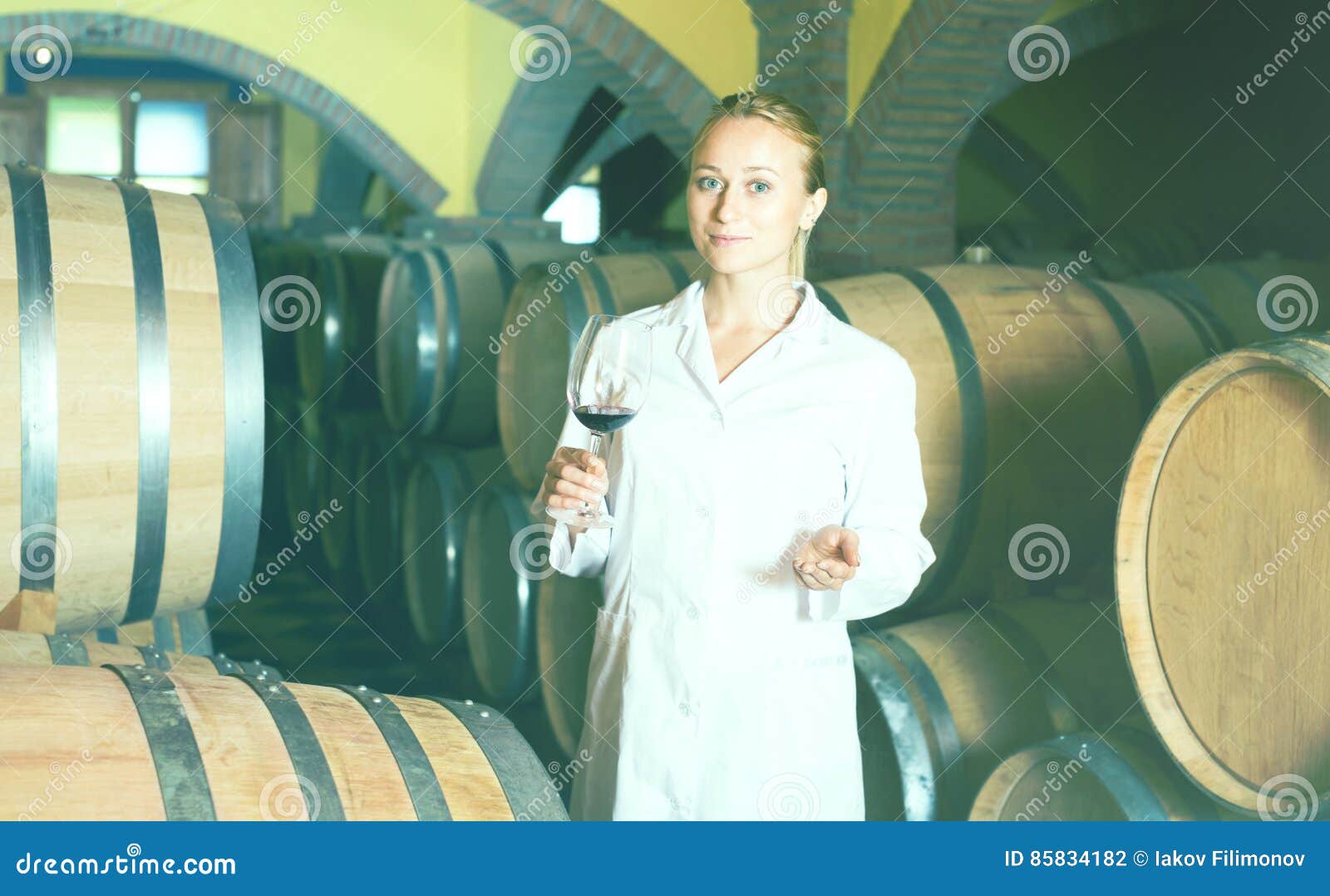 Female Wine House Worker Checking Quality of Product Stock Photo