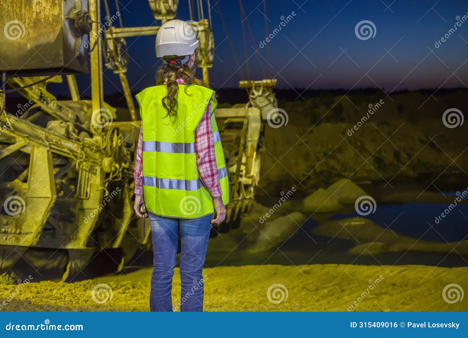 female worker lookis at sandpit on backgroud of
