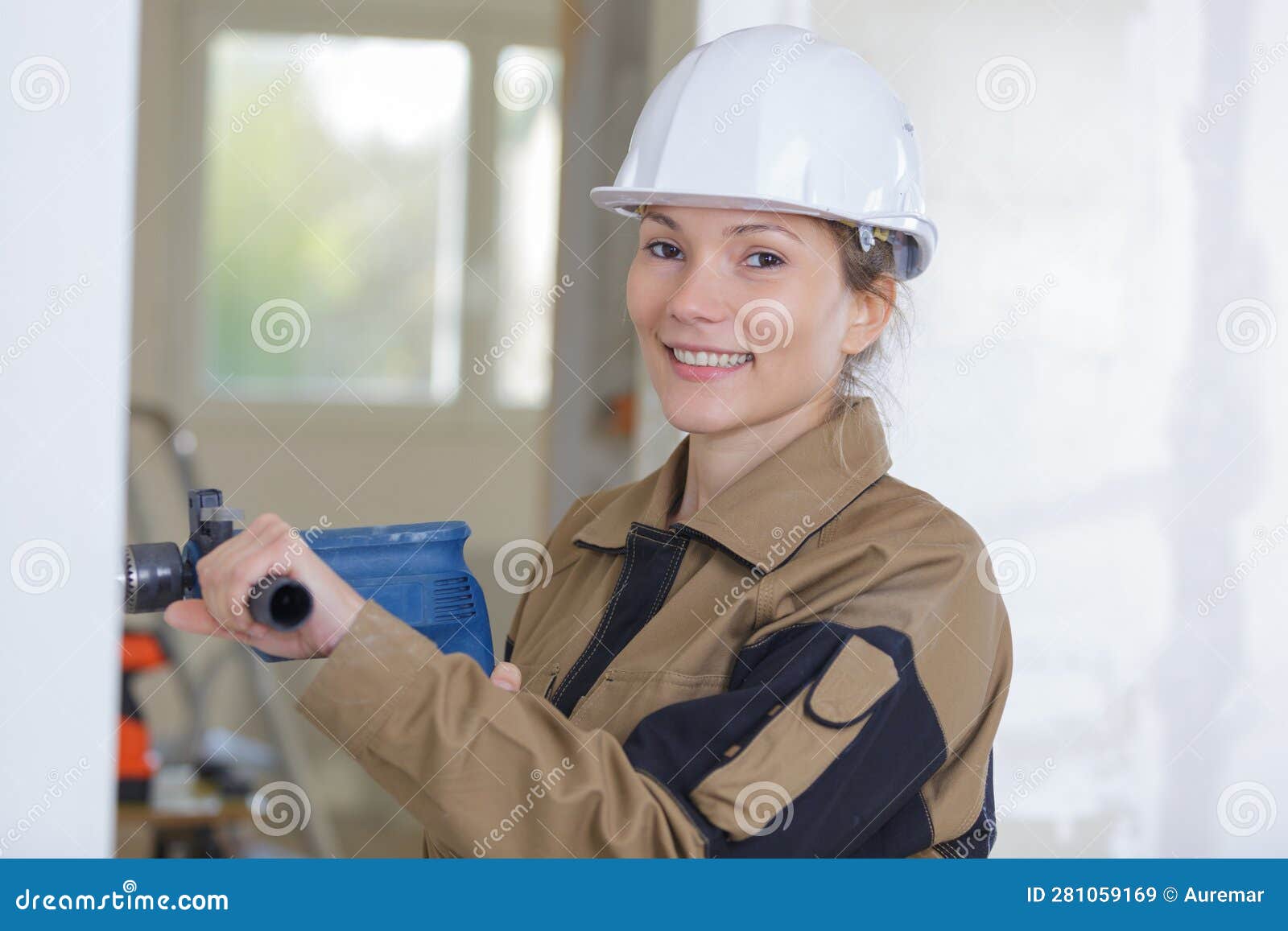 female worker sanding wall