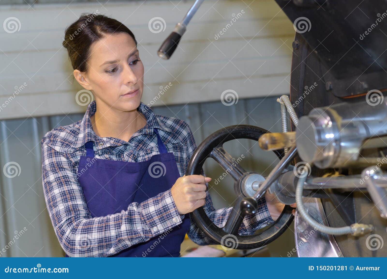 Female Worker Turning Wheel on Machine Stock Image Image of turning