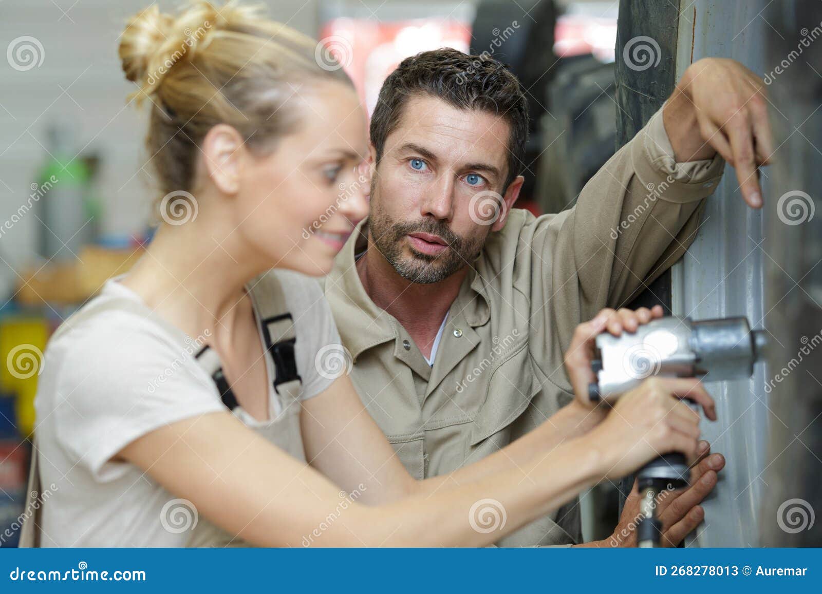 Female Worker Using Automatic Torque Wrench To Remove Bolts Stock Image