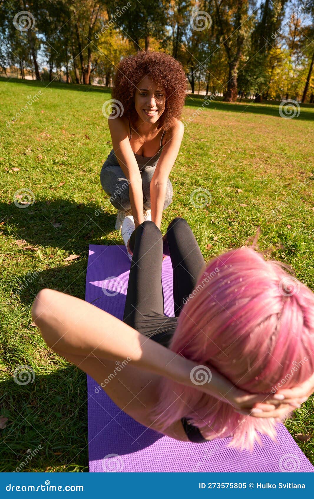 Female Working Out with Her Fitness Instructor in Park Stock Image