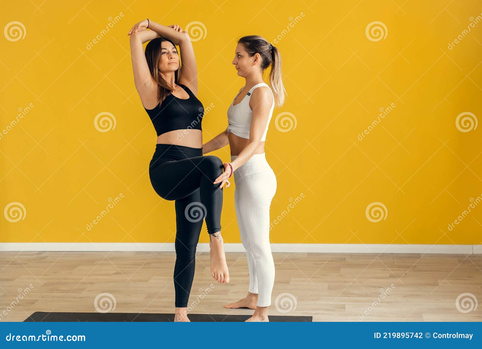 A Female Yoga Coach Controls the Performance of a Pose, Asana