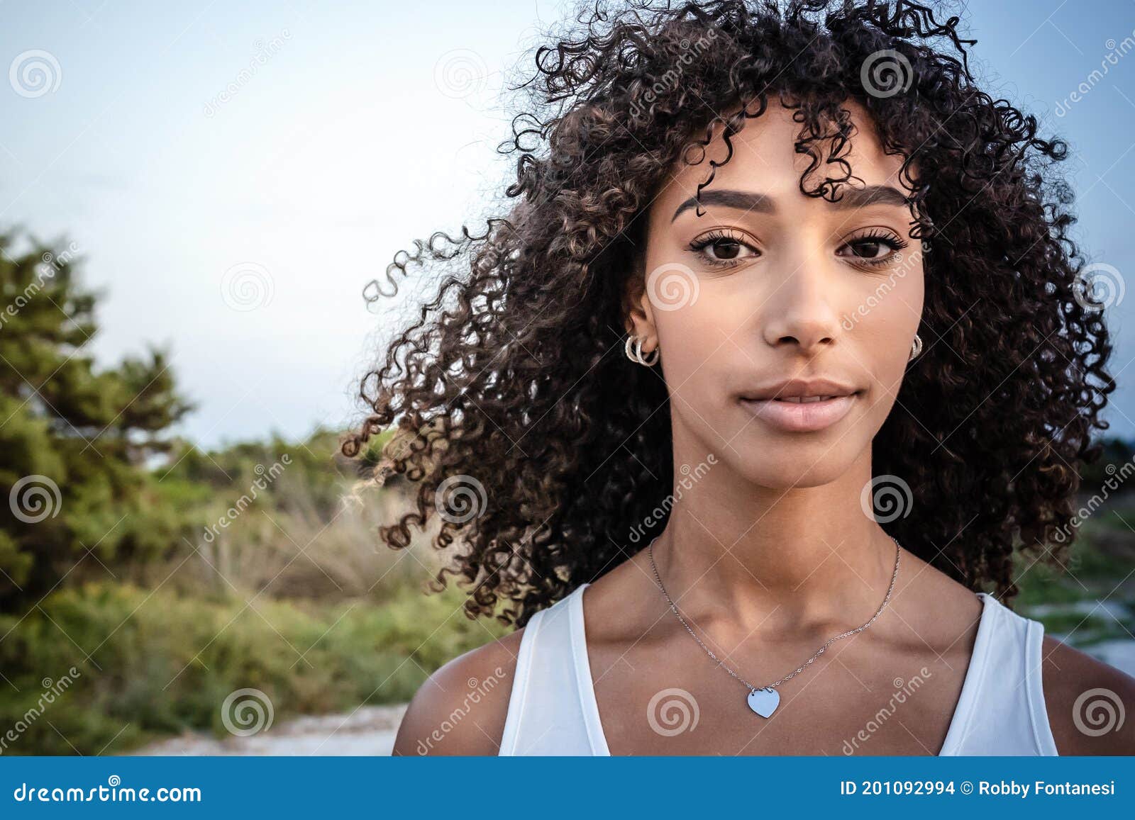 Femininity and Beauty in Nature: Close Up Portrait of Beautiful Black  Hispanic Young Woman with Curly Dark Long Hair Looking Stock Photo - Image  of artist, face: 201092994