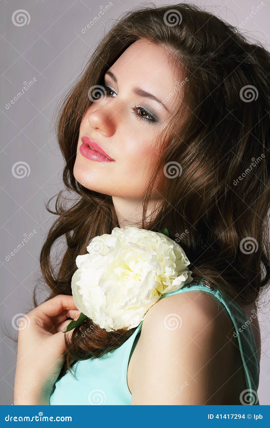 femininity. sincere brunette with white peony