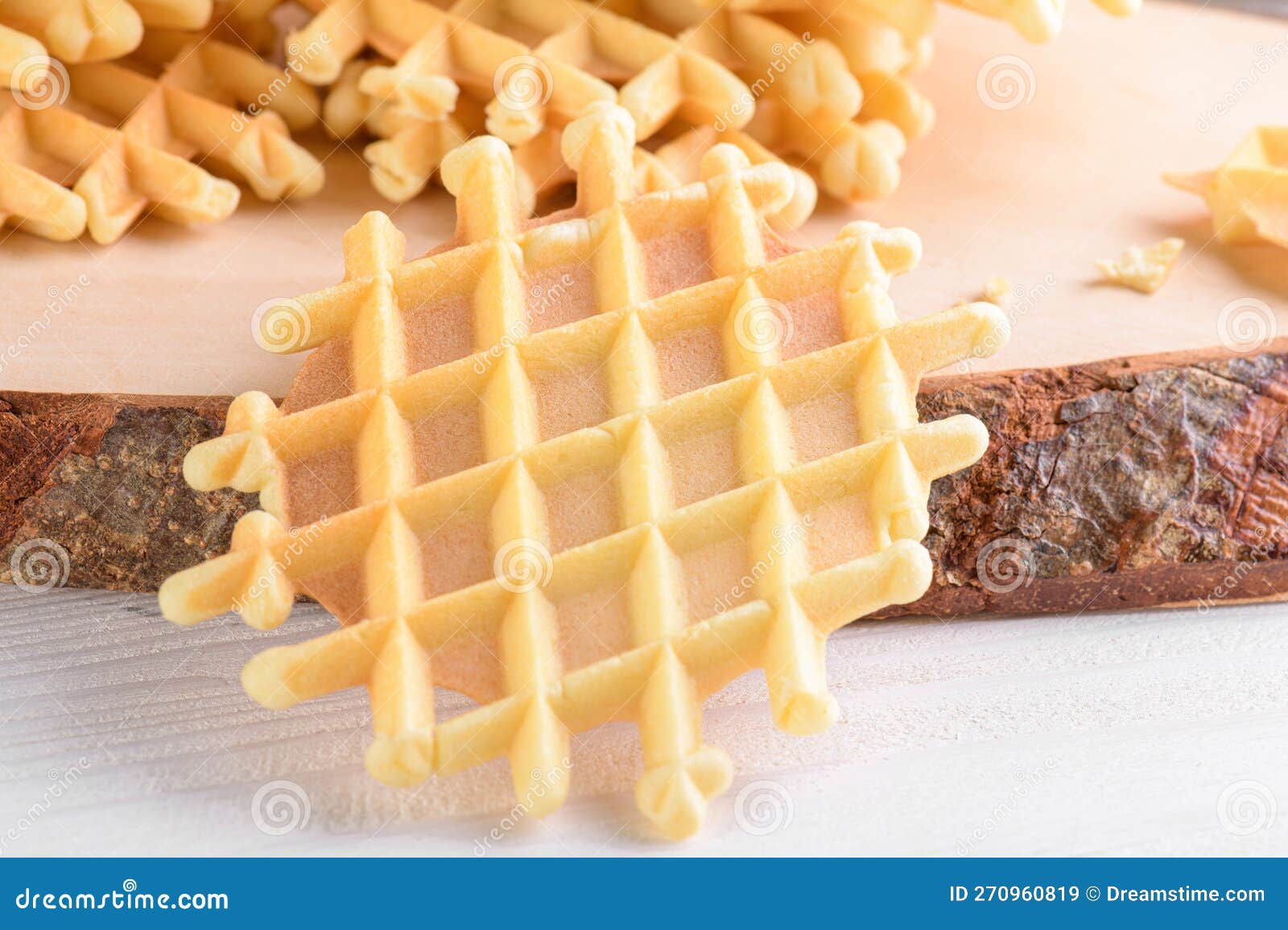 ferratelle or pizzelle a traditional dessert or cookies from abruzzo on a cutting board on a white wooden background