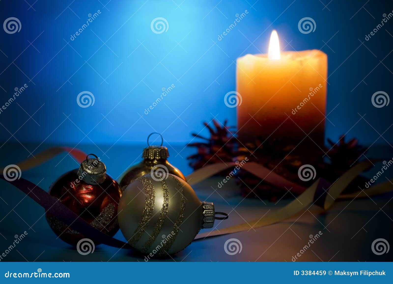 Festive background. Beautiful mysterious festive composition: candle with cones and christmas decorations. Focus on foreground