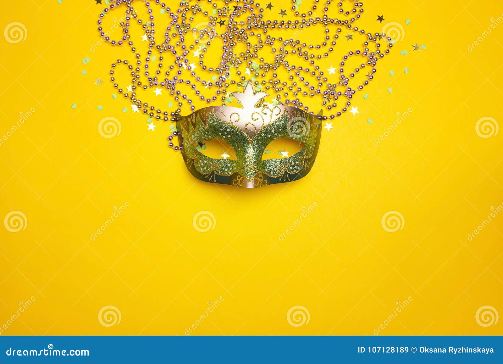 festive carnival mask and beads on a yellow background.