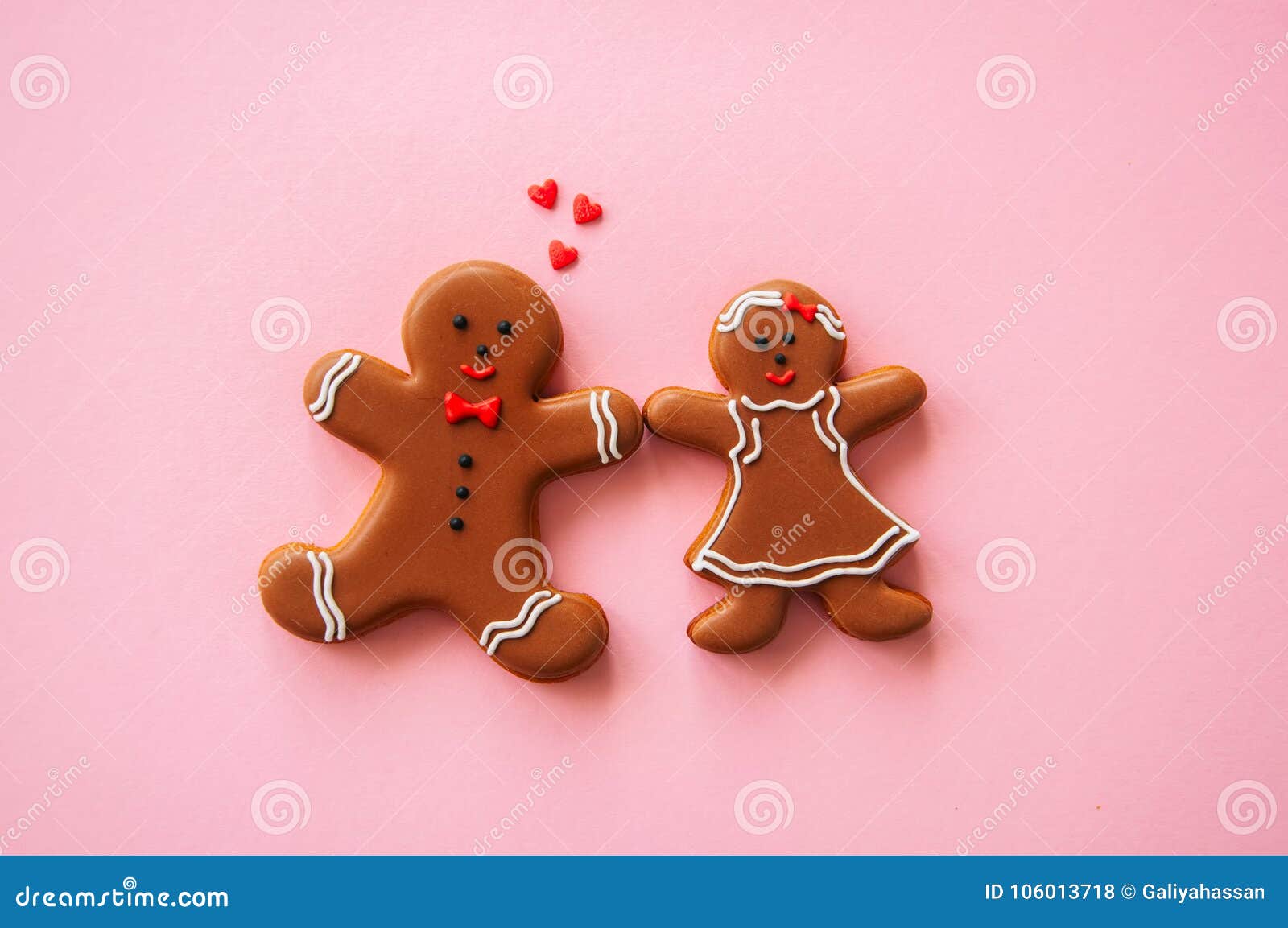 Festive Christmas concept background Gingerbread man and girl on a pink backdrop Top view