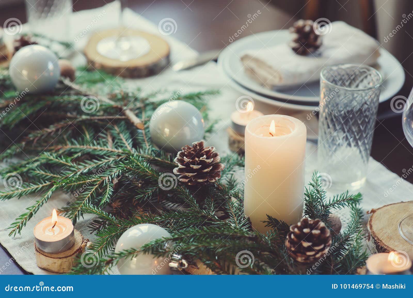 festive christmas and new year table setting in scandinavian style with rustic handmade details in natural and white tones