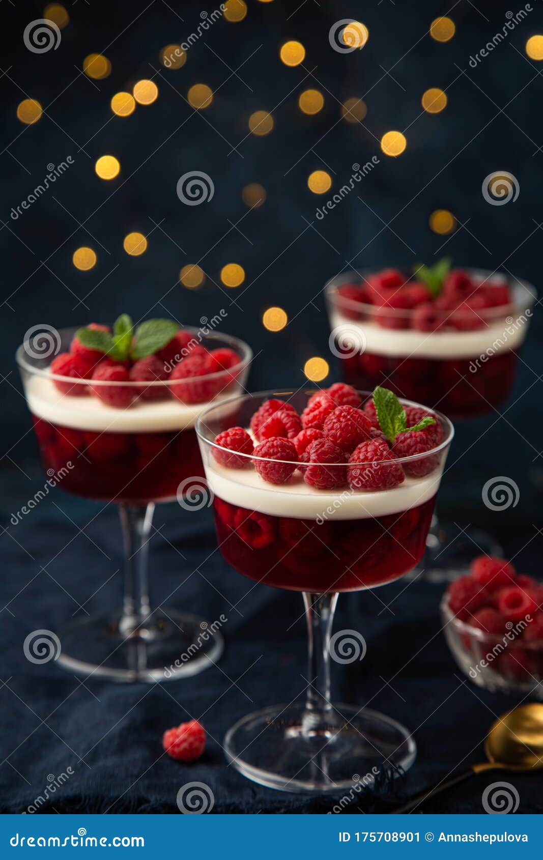 festive dessert with berry jelly, vanilla panna cota and fresh raspberry