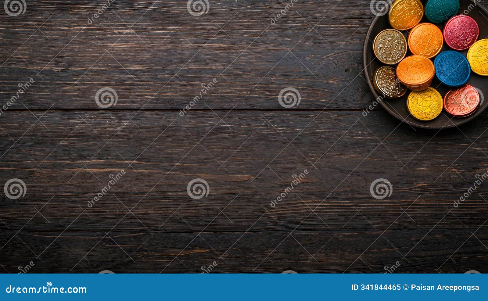 a festive display of colorful hanukkah coins on a rustic wooden table