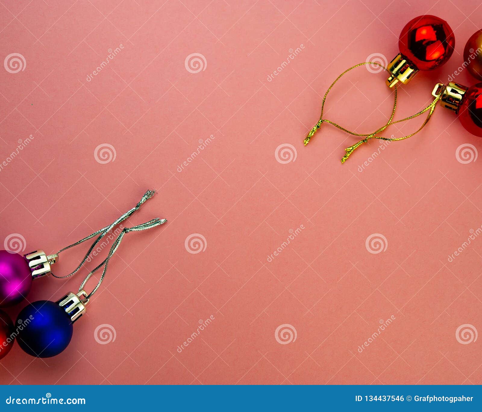 Festive Multicolored Decorative Balls on a Pink Background Stock Photo