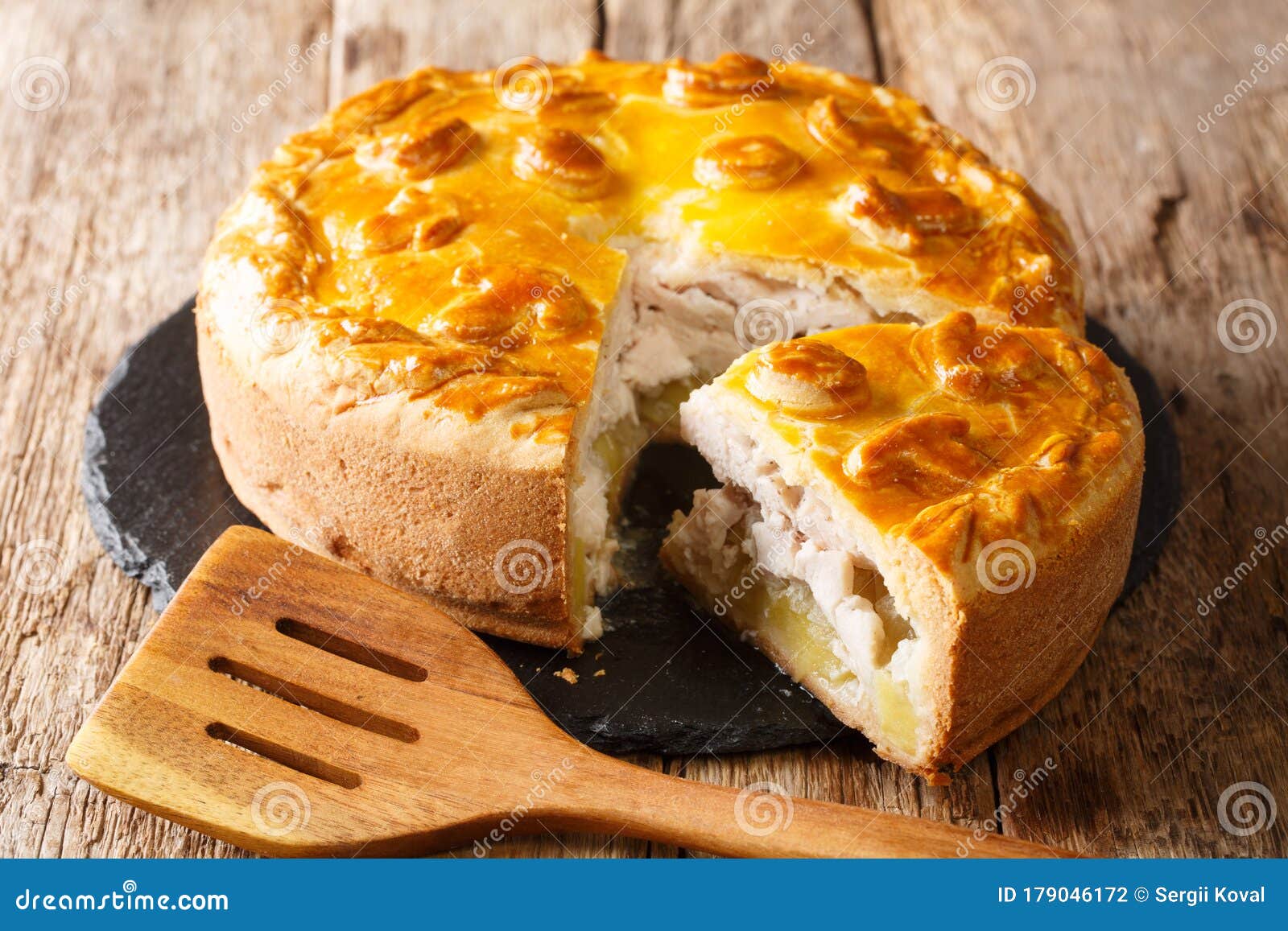 Festive Russian Pie Kurnik With Pancakes, Chicken And Potatoes, Cut Off  Piece With Layers Of Filling, Horizontal Stock Photo, Picture and Royalty  Free Image. Image 162527017.