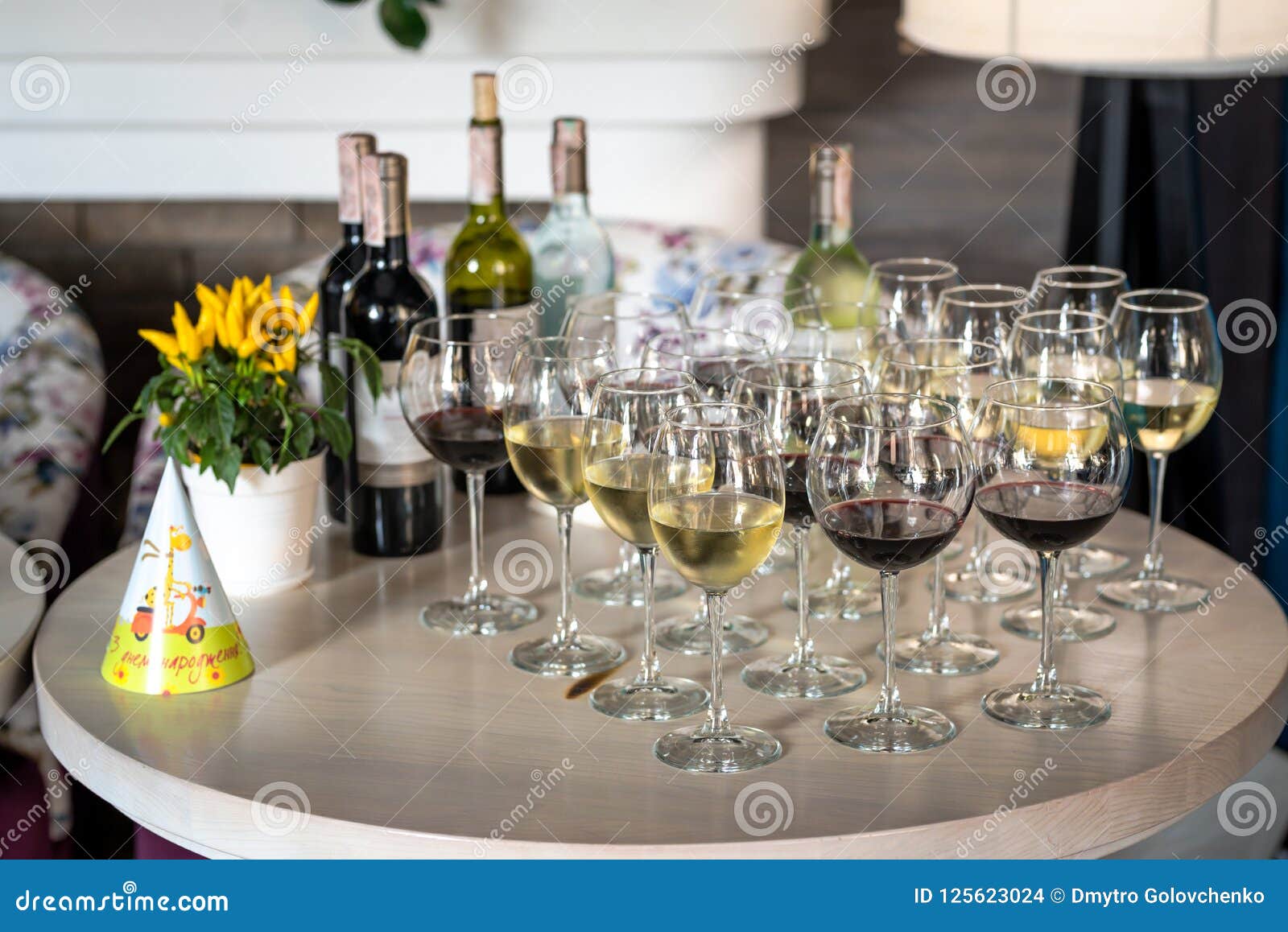 Festive Table with Glasses of Wine, Chilled Bottles of Wine Stock Photo
