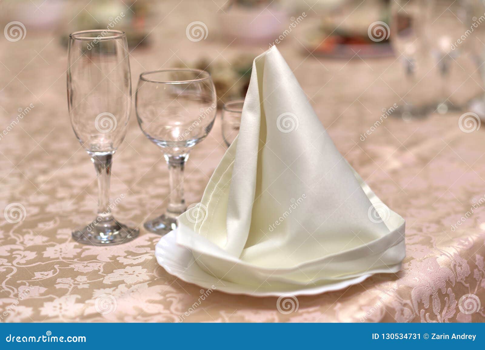 Festive Table Setting, Folded Napkin on a Plate and Three Glasses for Various Drinks Stock Image