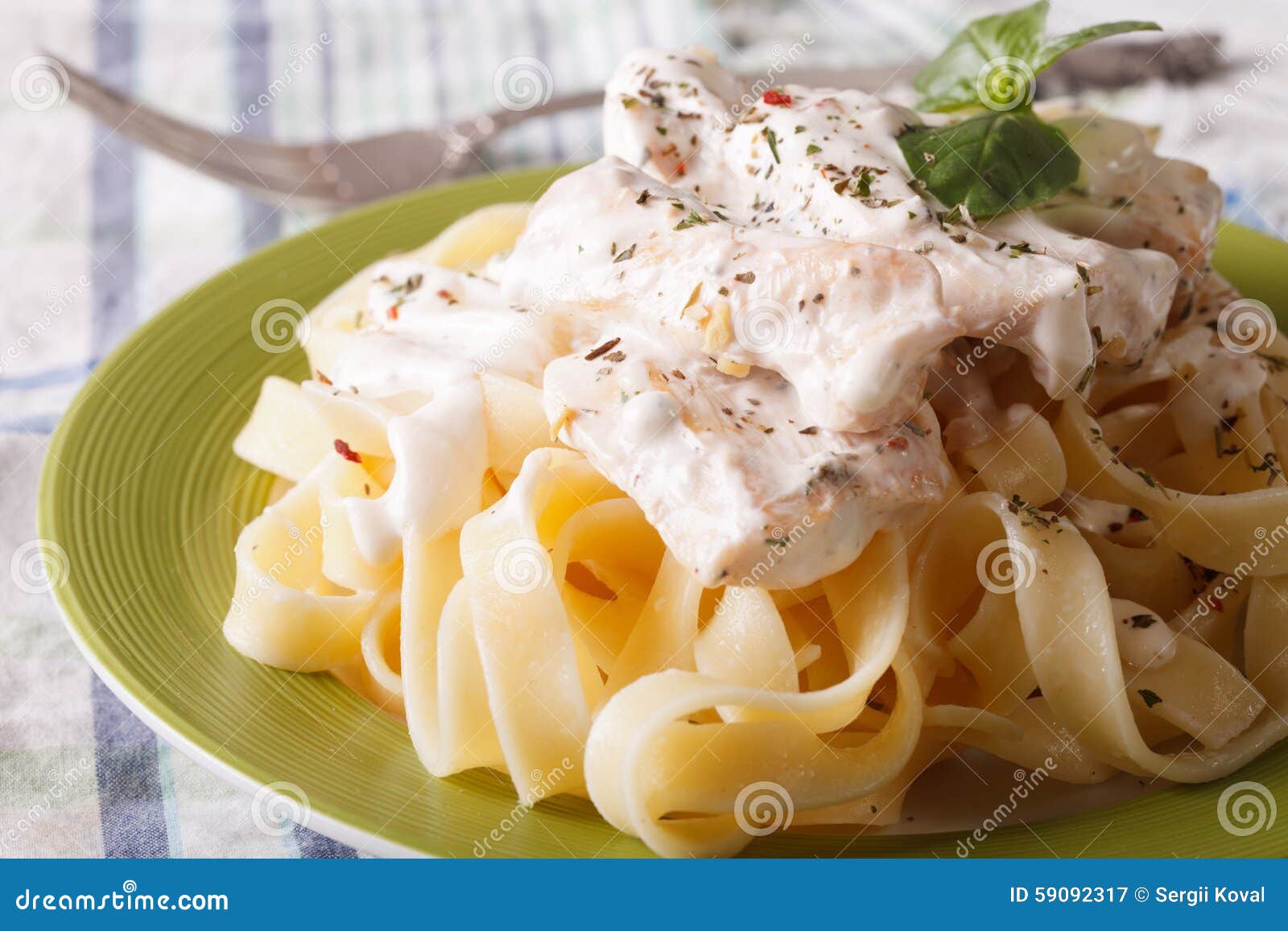 Fettuccine Pasta with Chicken and Cream Sauce Close-up. Horizont Stock