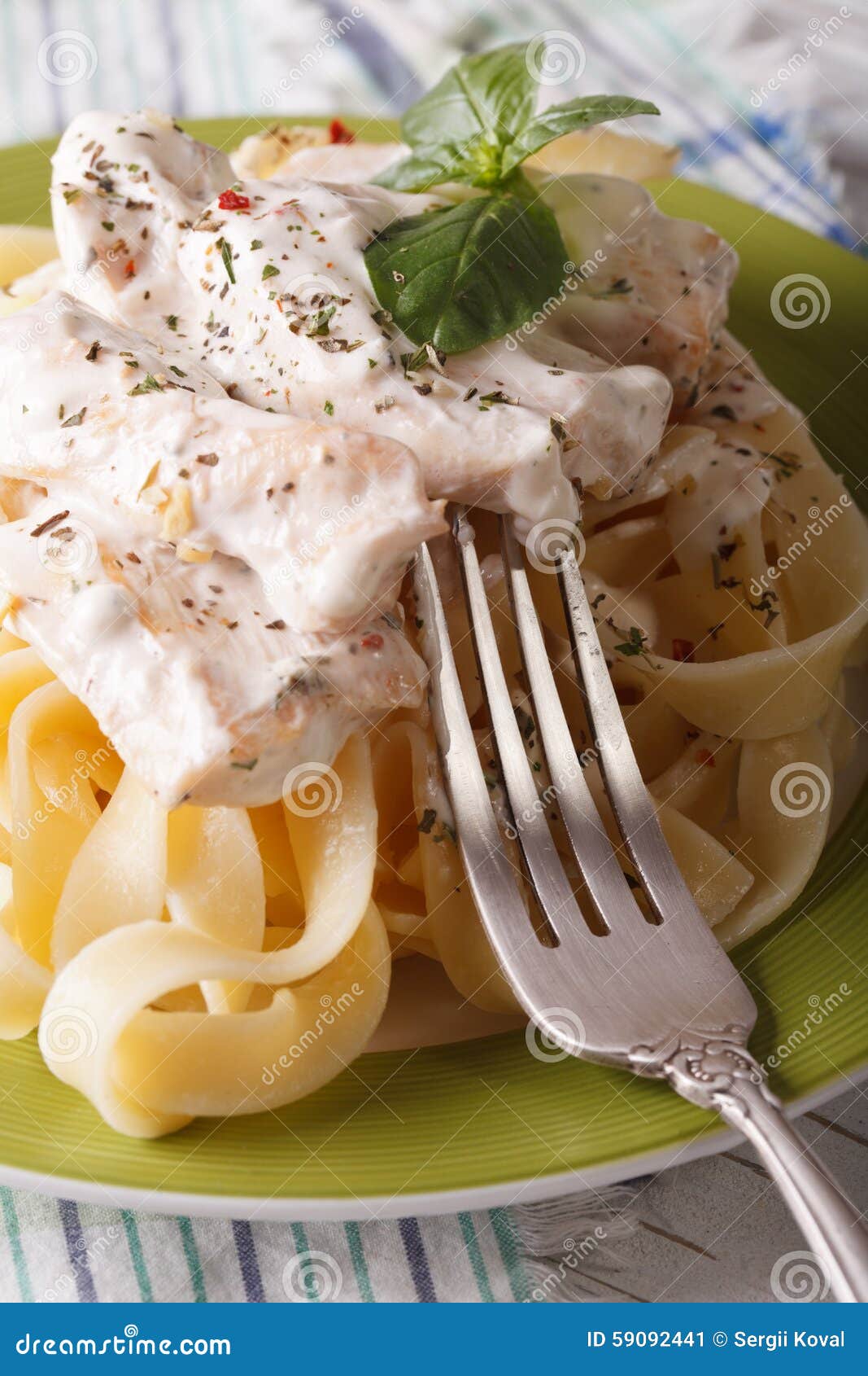 Fettuccine Pasta with Chicken and Cream Sauce Close-up. Vertical Stock