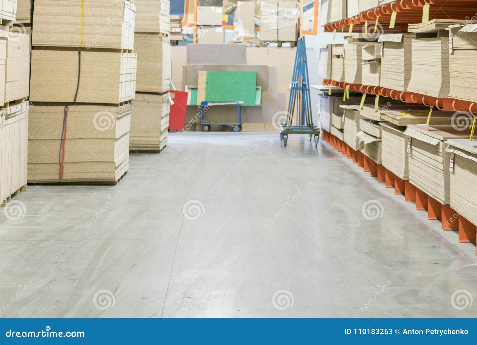 fiberboard and chipboard sheets on shelves in the building materials store.