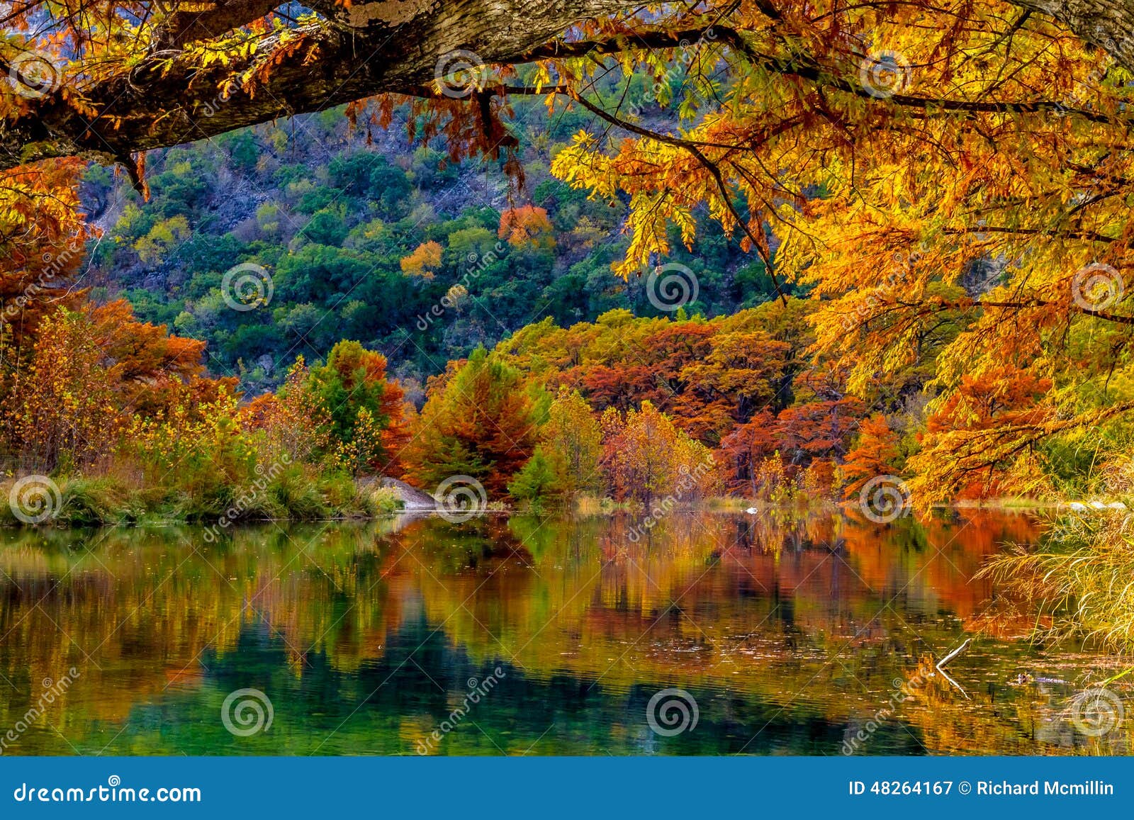 fiery orange reflections on the frio river at garner state park, texas